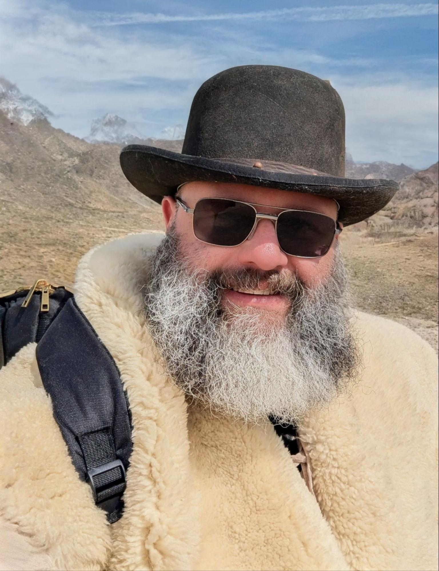 a woman hanging a vase on a shelf